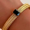 PULSERA DORADA DE ACERO CRISTAL NEGRO